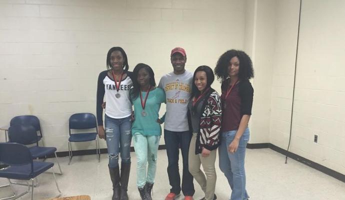 Members of the 2nd place 4x200M Relay Team with head coach Alton McKenzie